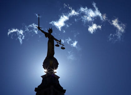 Justice statue silhouetted on Old Bailey